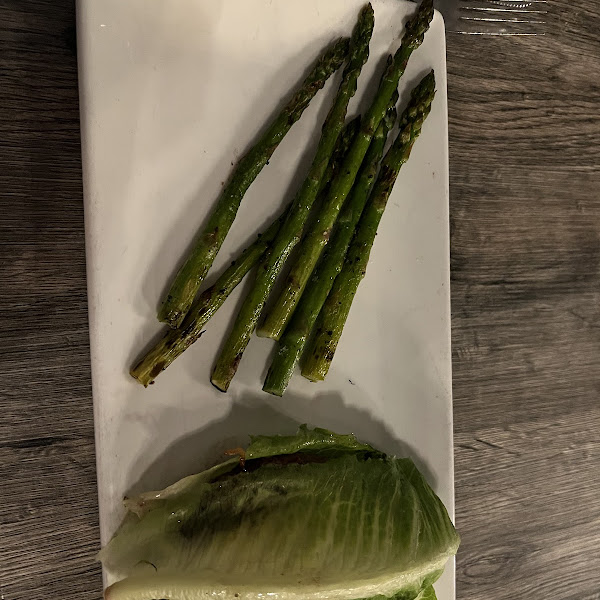 Delux burger in a lettuce wrap and asparagus substituted for fries