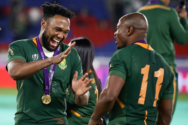 Lukhanyo Am and Mazakole Mapimpi celebrate after winning the Rugby World Cup 2019 Final match against England at International Stadium Yokohama on November 02, 2019 in Tokyo, Japan.