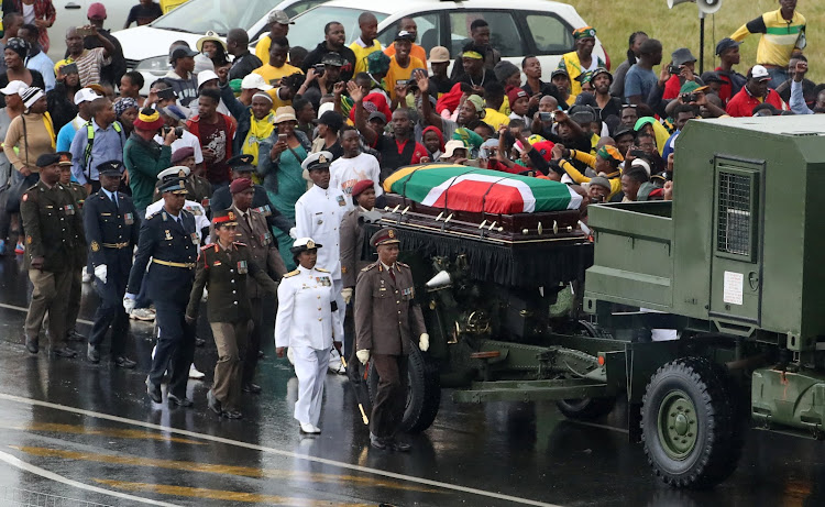 People line the streets to pay their respects as Winnie Madikizela-Mandela's coffin is taken from Orlando Stadium to Fourways Memorial Park on April 14 2018. The state funeral cost an estimated R35.7m, MPs heard on Monday.