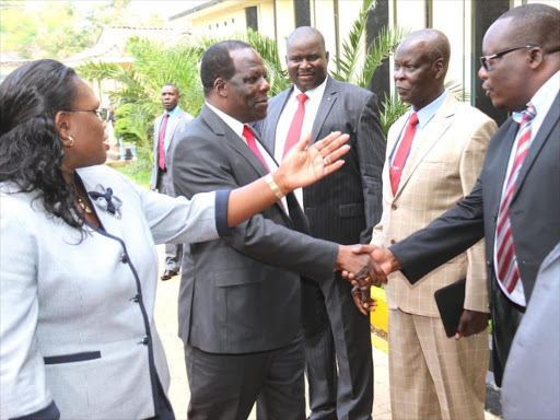 Kakamega Governor and LREB chairman Wycliffe Oparanya greets some Homa Bay MCAs as the assembly Speaker Elizabeth Ayoo leads him during the LREB forum at the county assembly on June 26,2018.Photo/Robert Omollo