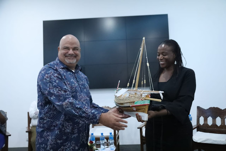 Lamu Governor Fahim Twaha gives a gift to Wayne Bright the Chief of Party USAID KUZA after unveiling the new disaster management policy a USAID-funded project at the Dream of Africa Resort in Malindi Kilifi county