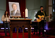 A candle and a portrait of British MP David Amess, who was stabbed to death during a meeting with constituents, are seen at the church of St Michael's and all Angels, in Leigh-on-Sea, Britain, October 17, 2021. 
