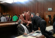 BACK TO JAIL Theo Jackson and Willem Oosthuizen leave the court.