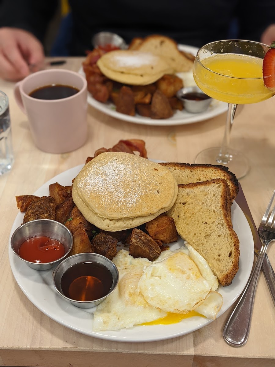 Farmers breakfast with bacon and a mimosa.