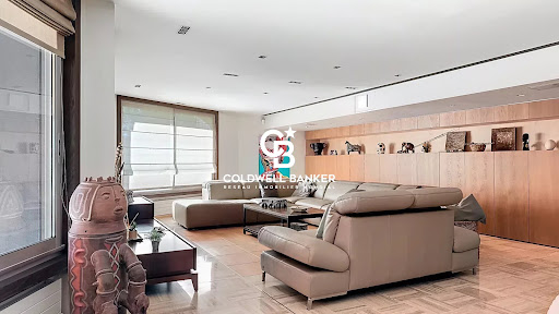 Modern living room with beige sectional sofa in this luxury property for sale in Les Herbiers ($1,020,001 - 289 m²)