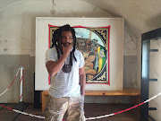 Artist Ayanda Mabulu stands in front of his controversial painting of President Jacob Zuma at Constitution Hill on 12 July 2016.