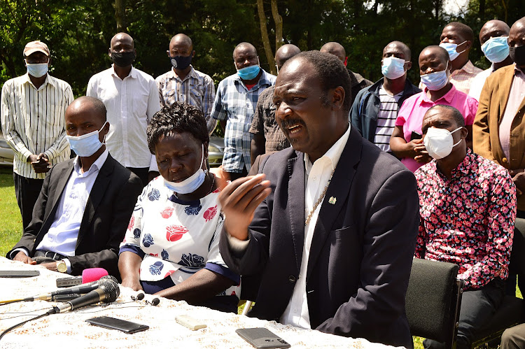 Malava Member of Parliament Malulu Injendi addressing the press outside CDF offices on Friday he is flanked by the area MCAs