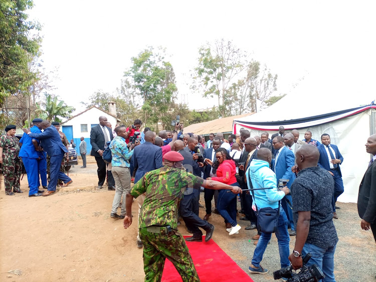 Journalist jostle to take photos of President William Ruto after arriving at Kitui Central primary school on October 23, 2022.