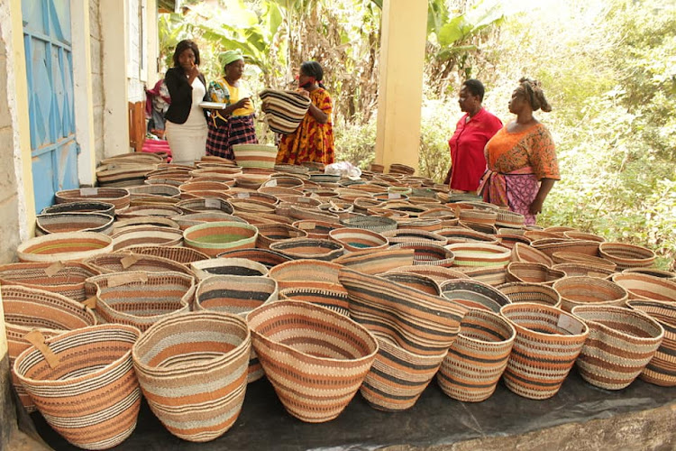 Chawia basket weavers display their baskets during an exhibition.