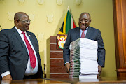 President Cyril Ramaphosa receives the fifth and final part of the state capture report from commission chair Raymond Zondo at the Union Buildings in Pretoria on June 22 2022.