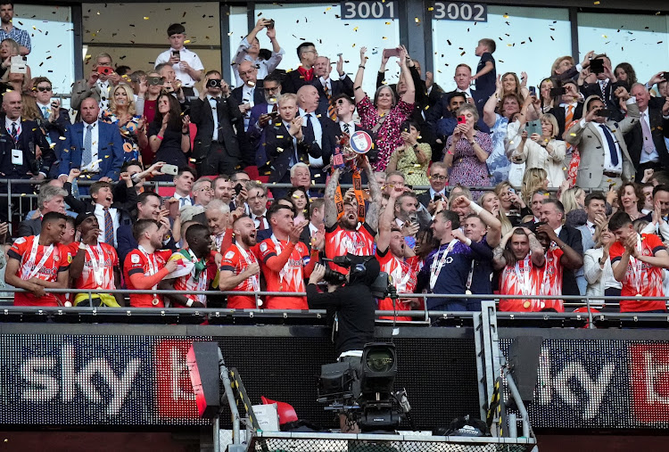 Luton Town players celebrate after getting promoted to the English Premier League