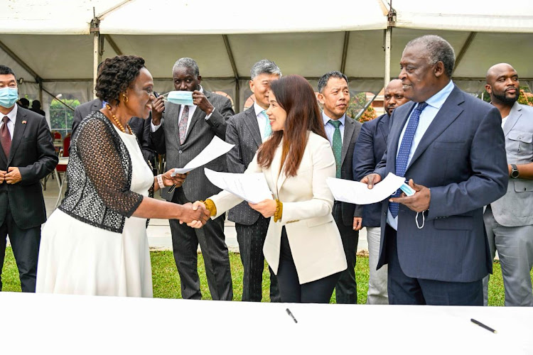 FRONT: Uganda Minister for Environment Anywar Atim, Luokong Technology CEO Wu Ying and Shiftings CEO Cyrus Jirongo when they exchanged an Memorandum of Understanding.