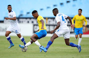 Themba Zwane of Mamelodi Sundowns challenged by Teboho Mokoena of SuperSport United during their DStv Premiership match at Loftus Versfeld Stadium on Wednesday.