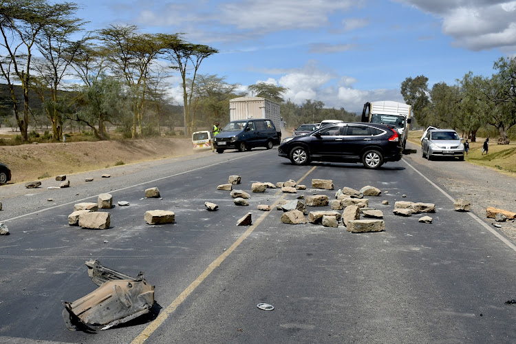 Flower farm workers and motorcycle operators block a section of the Nairobi-Nakuru highway after a worker was hit and killed by a speeding car near Panda Business park in Naivasha.