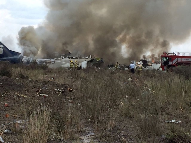 Rescue personnel work at the site where an Aeromexico-operated Embraer passenger jet crashed in Mexico's northern state of Durango on July 31, 201.