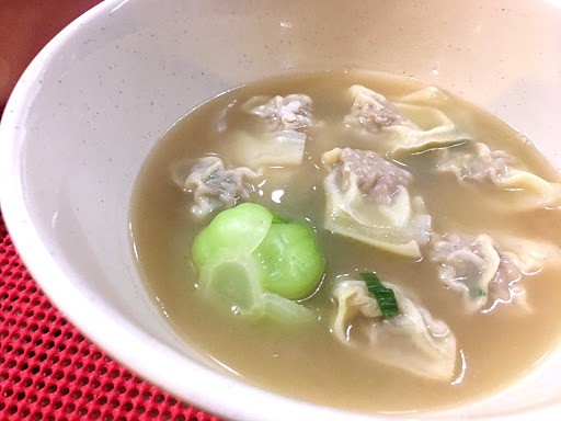 Wonton soup in a bowl with bok choy