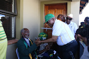 Former president Jacob Zuma greets struggle veteran Amos Ndwalane during the handing over of his new house in Lamontville in Durban in May.
