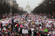 Protesters walk during the Women’s March on Washington, with the US Capitol in the background, on January 21, 2017 in Washington, DC. Large crowds attended the anti-Trump rally a day after President Donald Trump was sworn in as the 45th US president.  