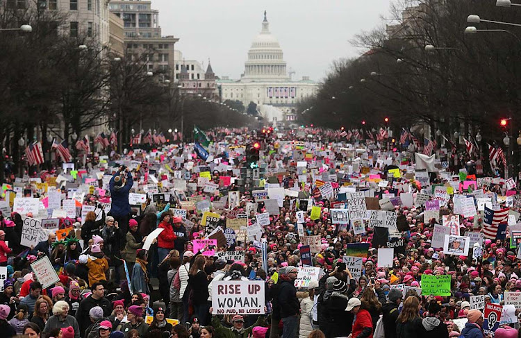 Protesters walk during the Women’s March on Washington, with the US Capitol in the background, on January 21, 2017 in Washington, DC. Large crowds attended the anti-Trump rally a day after President Donald Trump was sworn in as the 45th US president.