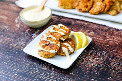 A plate of Low Carb Salmon Patties With Creamy Sauce.