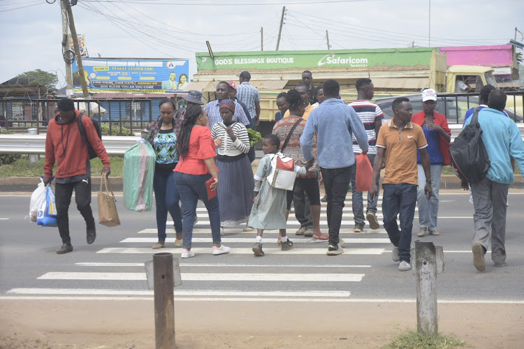 Juja residents cross the busy Thika superhighway at Highpoint area.