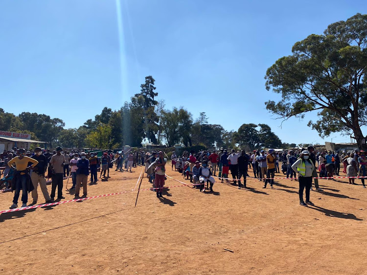 On a daily basis, scores of people gather to receive food parcels.