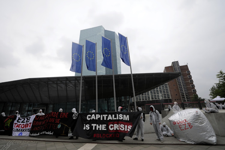 Climate activists from German civil disobedience movement Ende Gelande hold up banners during a protest outside the European Central Bank (ECB) ahead of the bank's rate announcement in Frankfurt, Germany, on Thursday, July 16, 2020. Picture: ALEX KRAUS/BLOOMBERG