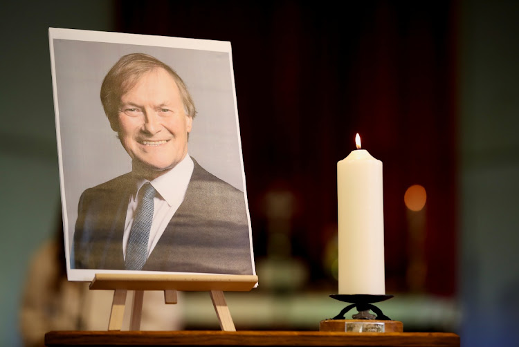 A candle and a portrait of British MP David Amess, who was stabbed to death during a meeting with constituents, at the church of St Michael’s and all Angels, in Leigh-on-Sea, Britain, on October 17 2021.