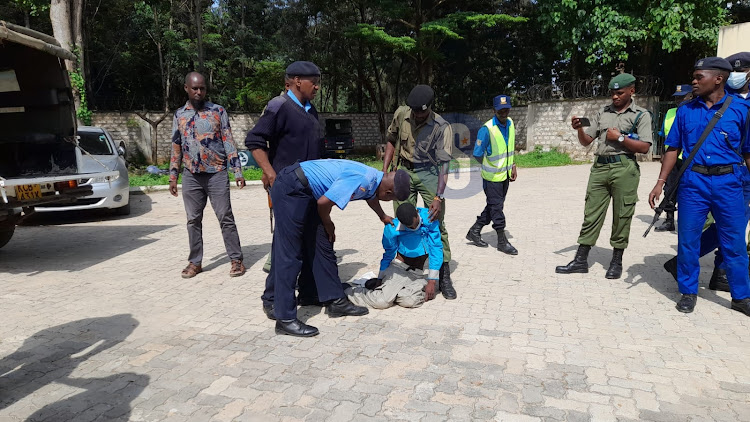 Followers of controversial Pastor Paul Mackenzie being supported by police after staging a hunger strike while in police custody for 10 days on June 14, 2023