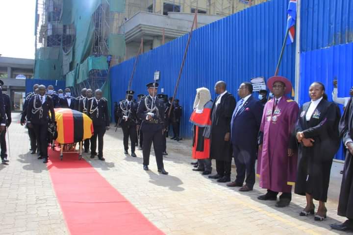 Police pall bearers arrive at the High court with the casket bearing remains of Justice Ruby Opio Aweri