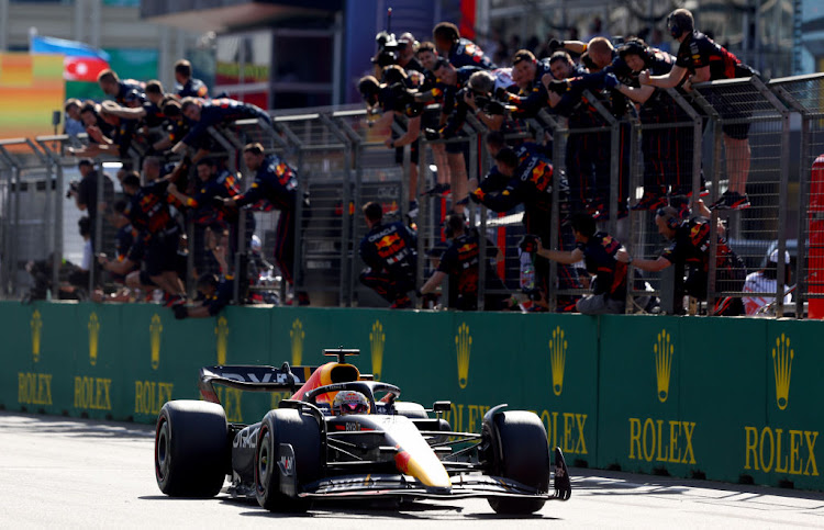 Race winner Max Verstappen passes his team celebrating on the pitwall during the F1 Grand Prix of Azerbaijan at Baku City Circuit on June 12, 2022 in Baku, Azerbaijan.