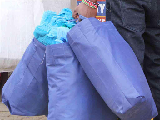 A trader carries eco-friendly reusable bags on Haile Selassie Avenue, Nairobi, following the ban on plastic bags by the government effective on August 28, 2017