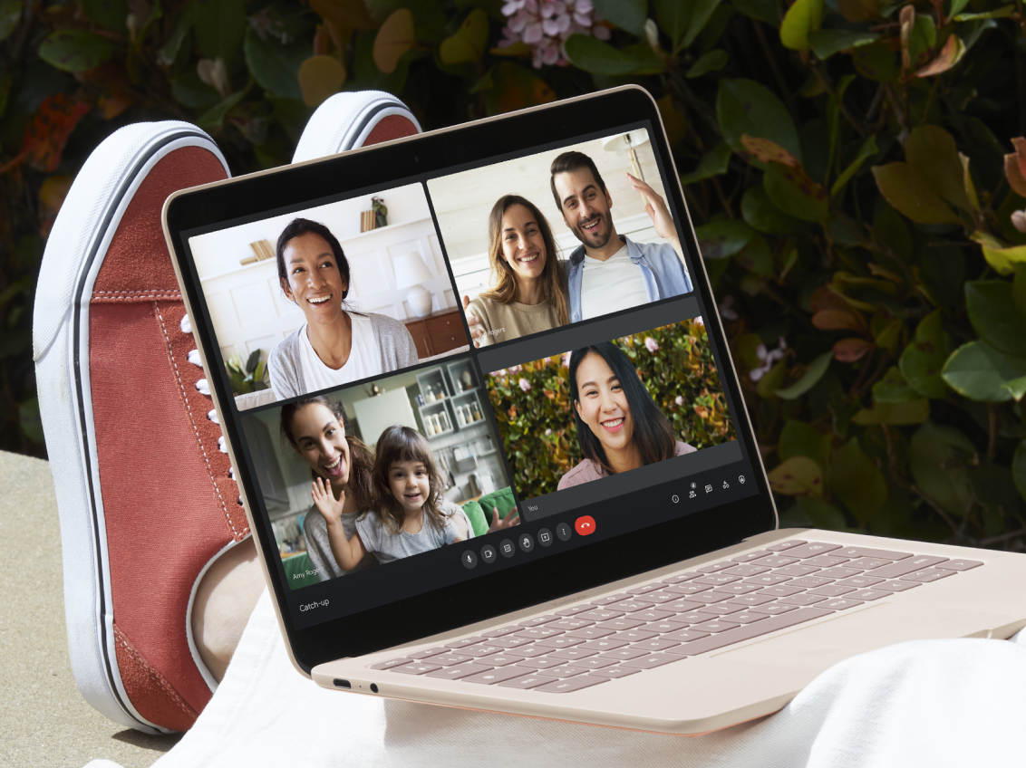 A laptop shows a group Google Meet call.