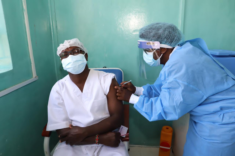 A medic administering the Covid-19 vaccine at the Moi Referral Hospital in Eldoret on March 18.