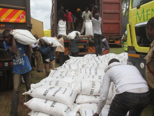 Some of the suspected contraband sugar being offloaded from one of the nine trucks. /Habil Onyango