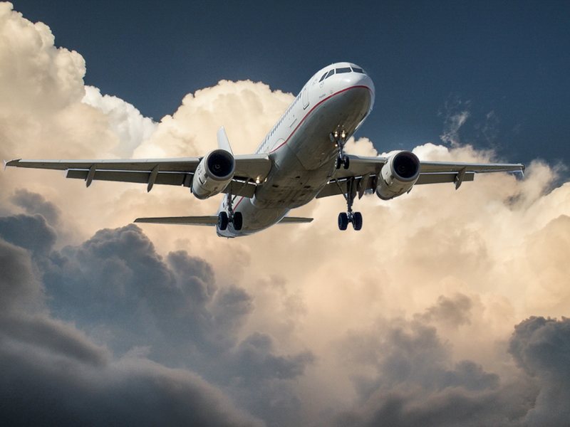 Airplane Flying Above Clouds