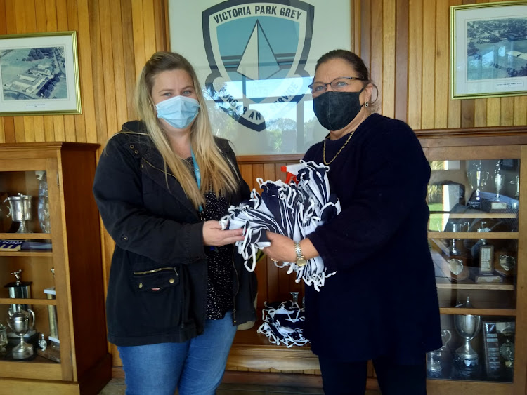 Victoria Park Grey Primary grade 6 head Jamie Stobbs receives masks for returning pupils from deputy principal Cathy Newman. The school’s management says it will be welcoming grades 6 and 3 on Monday and not grade R.