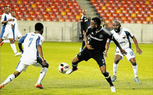 CAUGHT IN THE MIDDLE: Chippa United’s Paseko Mako, left, and Mpho Makola of Orlando Pirates in a tussle for possession during the Premier League match between the sides at Nelson Mandela Bay Stadium on Tuesday night. The Buccaneers won the match 1-0 Picture: GALLO IMAGES