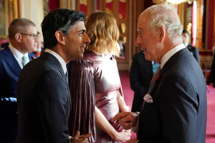 FILE PHOTO: King Charles III speaks with Prime Minister Rishi Sunak, during a reception at Buckingham Palace, London, ahead of the Cop27 Summit. November 4, 2022. Jonathan Brady/Pool via REUTERS/File Photo