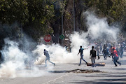 Police use tear gas to clear the streets on October 18 2018