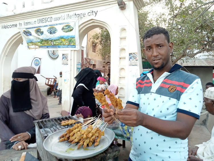 Mohamed Omar sells grilled beef skewers(mishkaki) during the Maulid festival in Lamu island.