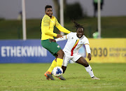 Dan Serunkuma of Uganda is challenged by Thendo Mukumela of South Africa during the 2019 Cosafa Cup match at Princess Magogo Stadium in Durban on June 4 2019.