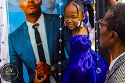 Siya Sesimani's daughter at her father's tombstone unveiling.