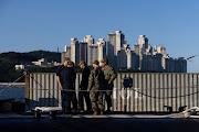 Members of the US Navy stand on the USS Kentucky ballistic missile submarine in Busan, South Korea, on Wednesday, July 19, 2023. 