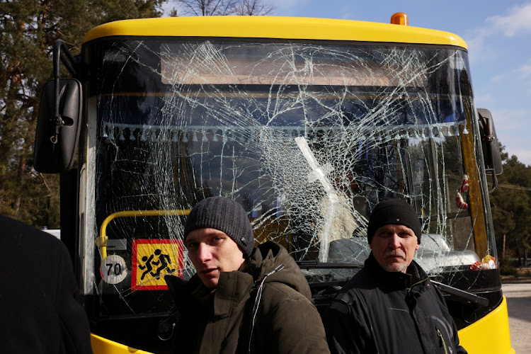 Yuri (R), a bus driver, and his son Ruslan, a doctor, stand in front of a bus damaged in this morning’s air strikes at a nearby military complex, while they wait outside Novoiavorivsk District Hospital on March 13, 2022 in Novoiavorivsk, Ukraine. Early this morning, a series of Russian missiles struck the International Center for Peacekeeping and Security at the nearby Yavoriv military complex, killing at least nine and wounding dozens, according to Ukrainian officials. The site is west of Lviv and mere miles from Ukraine's border with Poland, a NATO member.