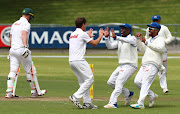 Michael Cohen of the Cobras celebrates with teammates after taking the wicket of Simon Harmer of the Warriors during day 2 of the Sunfoil Series 2017/18 Cricket match between the Cobras and the Warriors at Newlands Cricket Ground, Cape Town on the 17 October 2017.