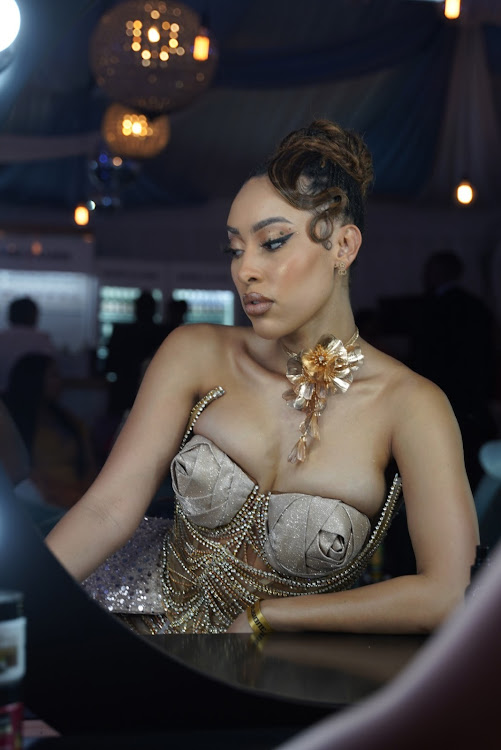 Sarah Langa looks breath taking in an updo with side front waves at the Durban July in Durban.