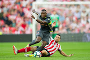 Aritz Aduriz of Athletic Club duels for the ball with May Mahlangu of Dinamo Bucarest during the UEFA Europa League Third Qualifying Round: Second Leg match between Athletic Club and Dinamo Bucarest at the Estadio de San Mames on August 3, 2017 in Bilbao, Spain. 