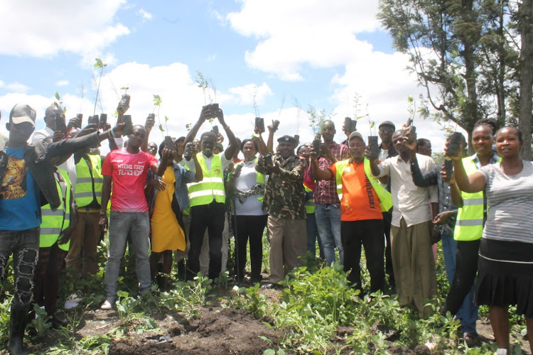 Mlolongo assistant county commissioner Punden Amos (2L) with area chief Peter Ndunda, Katani Level 4 Hospital representative Valen Ikokha and 4AS CBO cordinator Daniel Mwanza during a tree planting exercise at Kicheko dam in Syokimau, Machakos County on April 20, 2024.