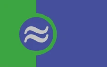 The romance-ambivalent flag; green on the left, blue on the right, with a blue circle in the purple and two white tildes in the circle